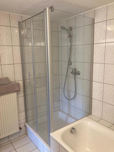 a bathroom with a shower and a bath tub at Ferienwohnung Loni in Kulmbach