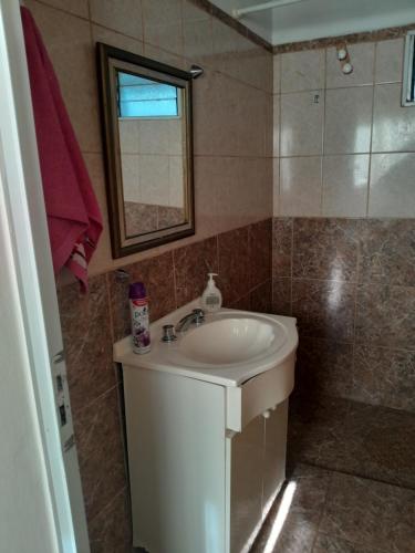 a bathroom with a sink and a mirror at Graciela in Villa Las Rosas