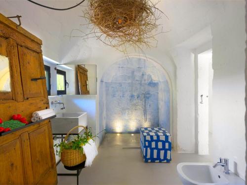 a bathroom with a sink and a mirror at Cocotrullo in Ostuni