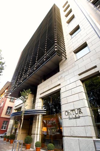a building with a sign on the front of it at Ontur Izmir Otel in Izmir