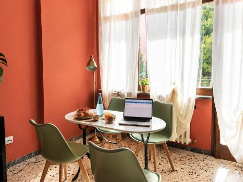 a dining room with a table with a laptop on it at Interi Appartamenti in Centro - Holiday & Wi-Fi Ultra in Campobasso