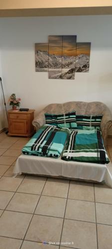 a bed sitting on a tiled floor in a bedroom at Ferienwohnung Klaus in Warngau