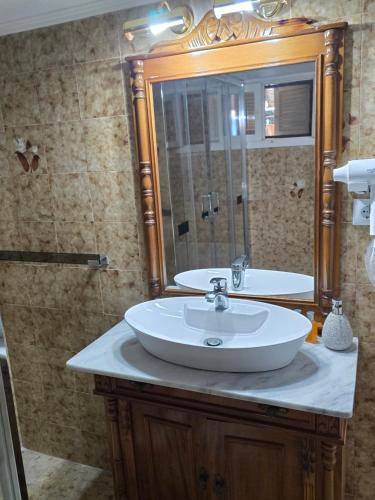 a bathroom with a sink and a mirror at Anna-Maria in Nea Kallikrateia