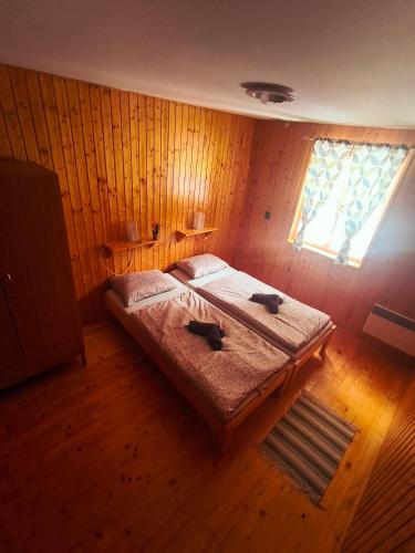 a bedroom with two dogs sitting on a bed at Grizzly Krpáčovo in Dolná Lehota