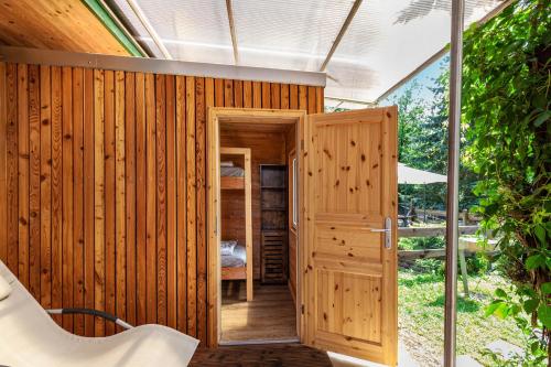 a wooden room with a wooden door and a window at Ferienhaus 204 in Zadelsdorf