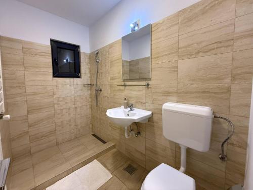 a bathroom with a toilet and a sink at Greenstone Land - Corbu in Năvodari