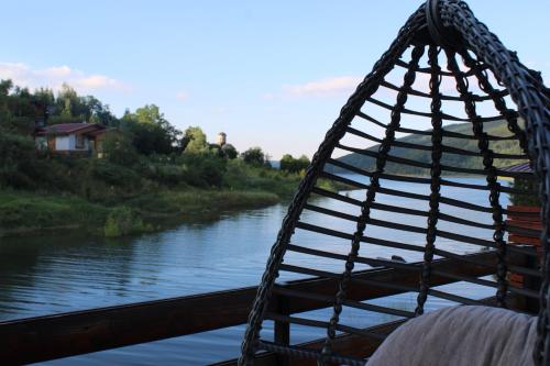 a swing on a bridge over a river at Villa Beti in Mavrovo