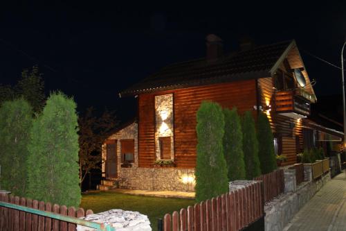 a wooden house with a fence in front of it at Villa Beti in Mavrovo