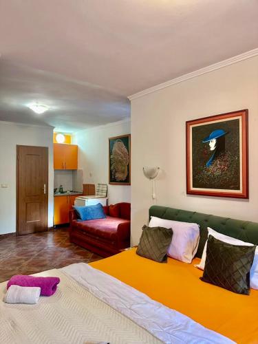 a living room with a bed and a couch at ApartMonte in Budva
