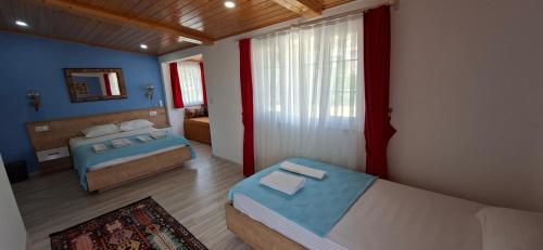 a bedroom with two beds and a mirror at Akay Hotel in Patara
