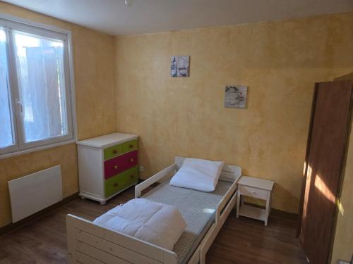 a small bedroom with a bed and a window at Maison proche bourg in Piégut-Pluviers