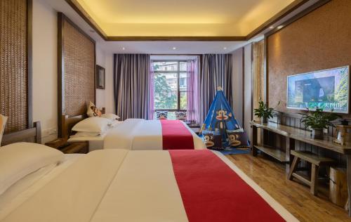a hotel room with two beds and a television at Zhangjiajie Yun Hai Hotel- Ancient Chinese Style Hotel,Tea Culture Experience, Realxing Class,Free Breakfast ,Local Travel Guide and Book Tickets, Gem Perporty in Zhangjiajie