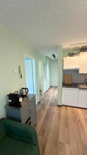a kitchen and a living room with a table and a couch at LE VOLPI Marilleva 1400 in Marilleva