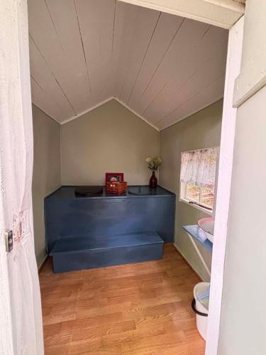 a room with a blue bed and a toilet at Jennys tent in Saltvik