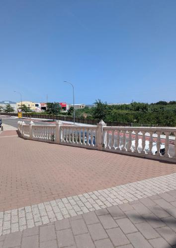 a white railing on a brick sidewalk next to a road at Ca TONI in Daimuz