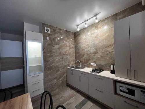 a kitchen with a sink and a counter top at Comfort in Chernihiv