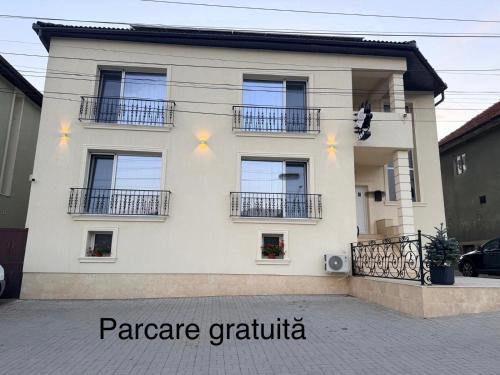 a large white house with windows and balconies at Kaleh Boutique Villa in Orşova