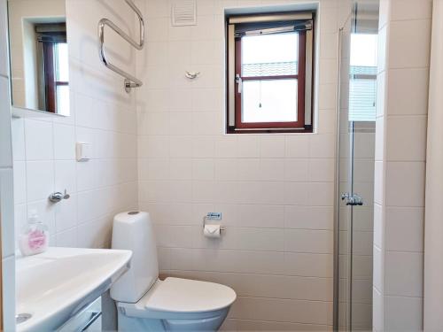 a bathroom with a toilet and a sink and a shower at Cozy Cabin with Fireplace in Åre