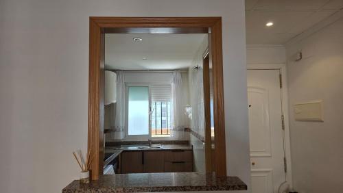 a kitchen with a mirror and a sink in a room at Vistamar -primera linea de playa in El Borseral