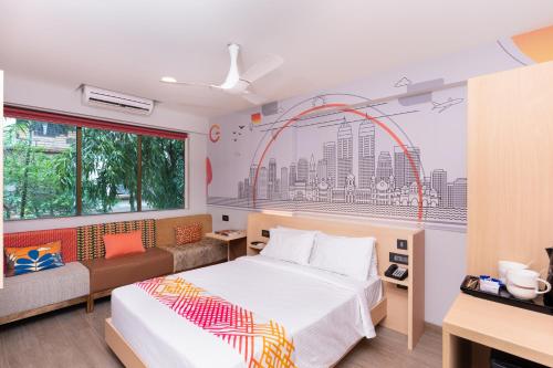 a bedroom with a bed and an arch painting on the wall at Ginger Thane in Thane