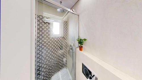 a shower with a glass door in a bathroom at Okto in Archangelos