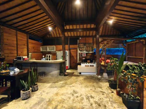 a large kitchen with a counter and a stove at Puri Sadewa Balangan in Jimbaran