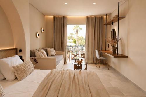 a bedroom with a bed and a desk in a room at Ilios Hotel, Adults Only in Laganas