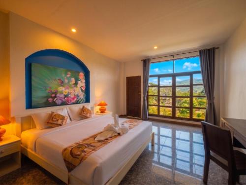 a bedroom with a bed and a large window at The Moon Rabbit Resort Pai in Pai