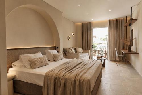 a bedroom with a large bed in a room at Ilios Hotel, Adults Only in Laganas