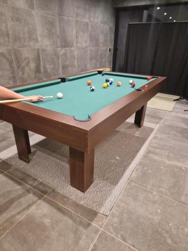 a pool table with balls on top of it at Chalet 1600 Kopaonik & Spa in Kopaonik