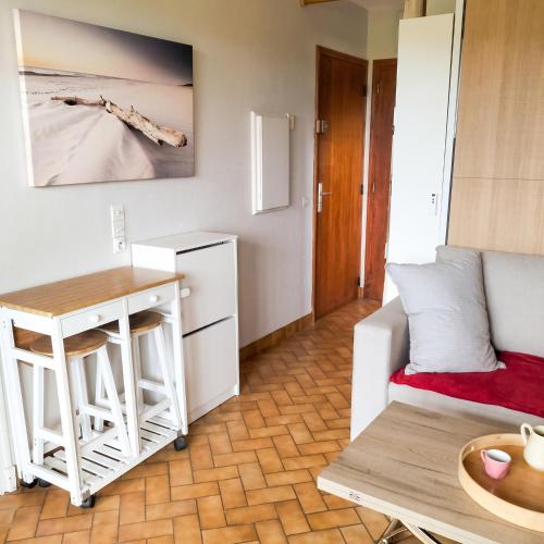 a living room with a couch and a table at Studio cosy avec terrasse et barbecue à Cazaubon - 28 m² in Cazaubon