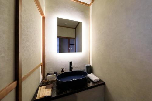 a bathroom with a sink and a mirror at 西伊豆 巡り in Ukusu