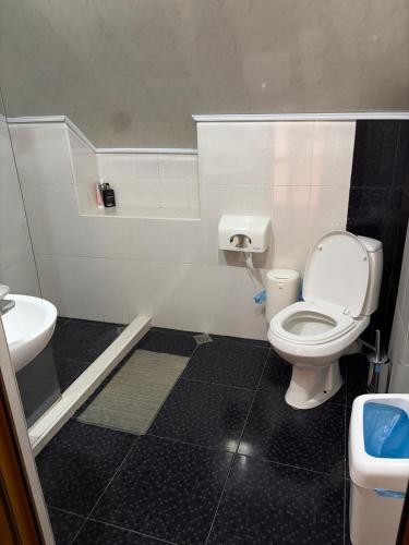 a bathroom with a toilet and a sink at Yvette B&B in Garni