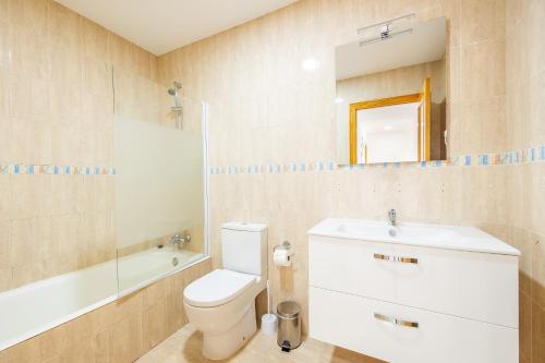 a bathroom with a toilet and a sink and a mirror at Ferrera Soul 2a in Felanitx