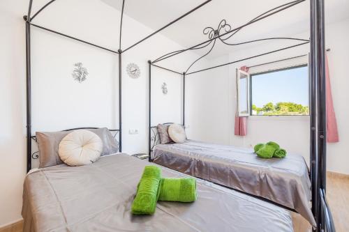 a bedroom with two beds and a mirror at Ferrera Soul 2a in Felanitx