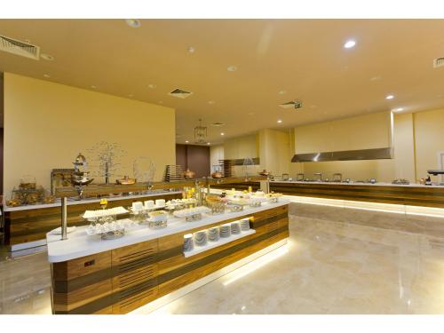 a restaurant with a buffet in a large room at Euphoria Batumi Convention & Casino Hotel in Batumi