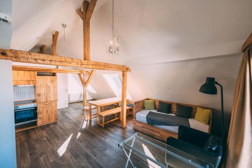 a room with a bed and a couch and a table at Stadthaus - Gut Hügle Collection in Ravensburg