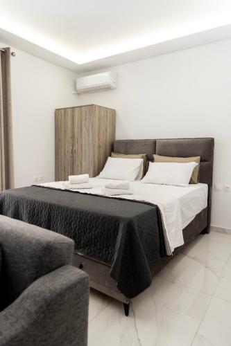 a bedroom with a large bed with a wooden headboard at Beautiful Apartment in Larisa