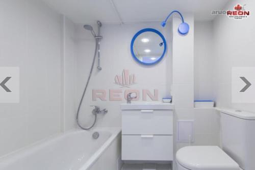 a bathroom with a white toilet and a shower at Cozy Loft Studio, one open space, in great location in Vilnius