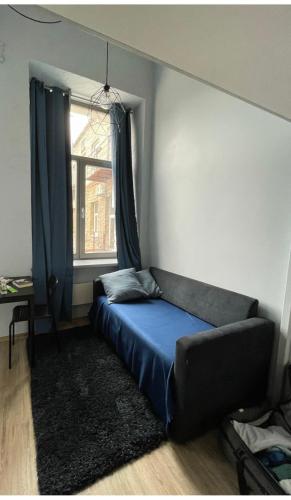 a bed in a room with a window at Cozy Loft Studio, one open space, in great location in Vilnius