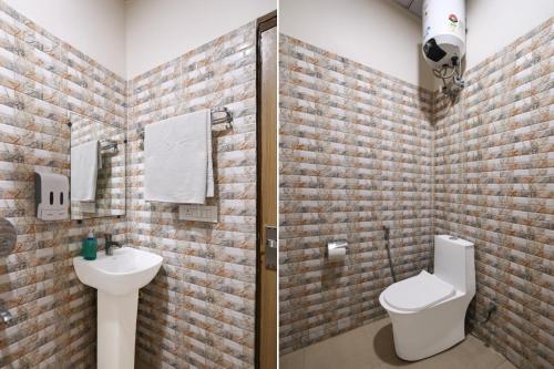 a bathroom with a toilet and a sink at Hotel Palm Paradise in Noida