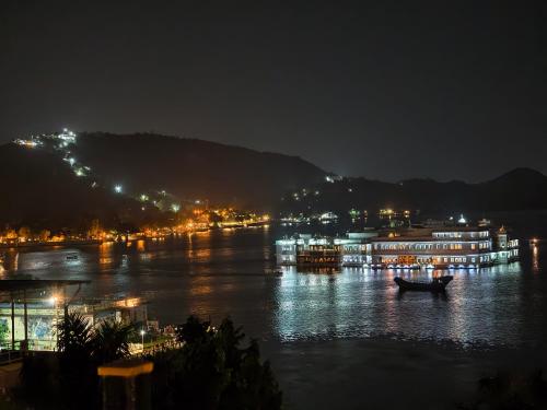 a boat on the water at night at Hotel Lake Star Bistro in Udaipur
