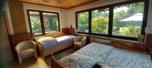 a bedroom with two beds and two windows at Landgut Pinnow in Murchin