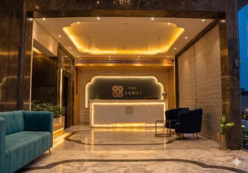 a lobby of a hotel with a couch and a table at Hotel The Sawai in Jaipur