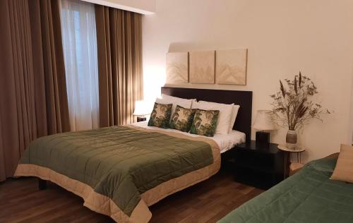 a hotel room with a bed with two pillows at Bhurban Valley Cottages 2 in Bhurban