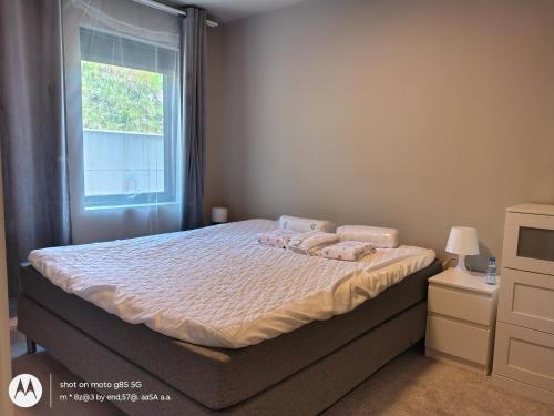 a bedroom with a bed with two pillows and a window at Pia Apartment in Bykle