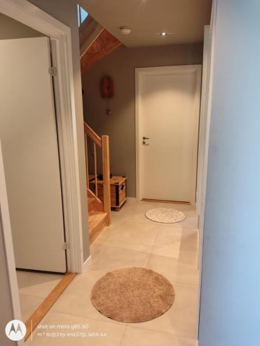 a hallway with a door and two rugs at Pia Apartment in Bykle