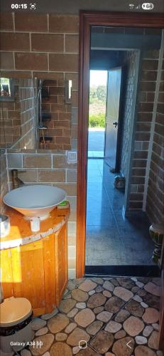 a bathroom with a sink in a brick wall at Caslune in El Bidha