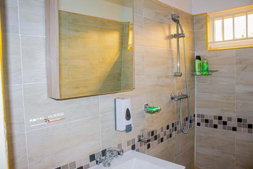 a bathroom with a sink and a shower at 7Palms Executive Lodges in Ndola