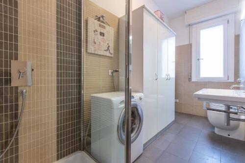 a bathroom with a washing machine and a sink at Borgo House, Bologna by Short Holidays in Bologna